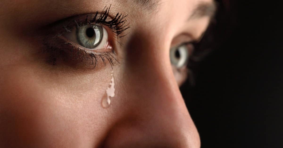 Woman cries, up close.