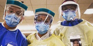 Médicos colam fotos deles sorrindo no jaleco para tranquilizar pacientes sobre COVID-19